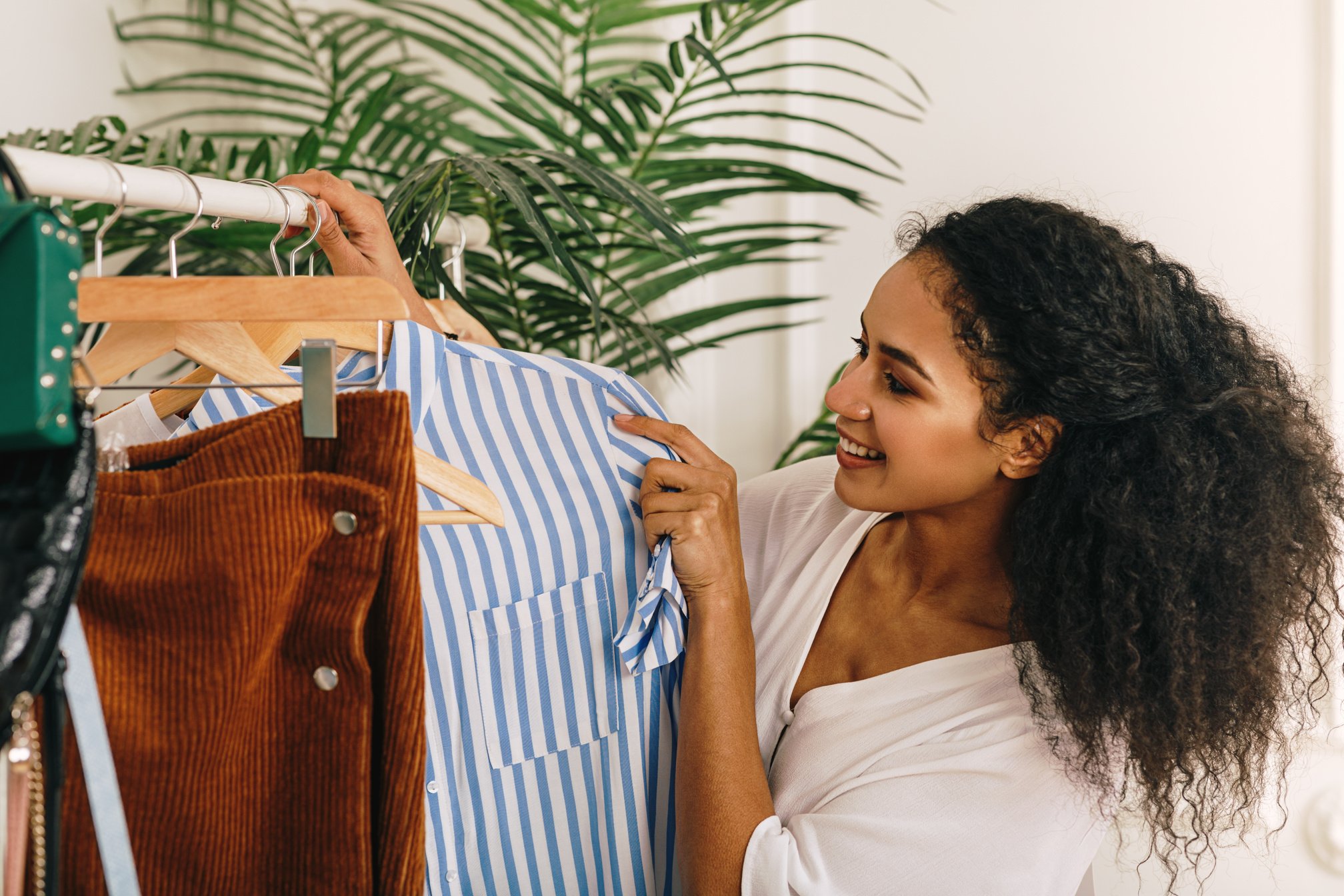 Girl Choosing Clothes from a Clothes Rack